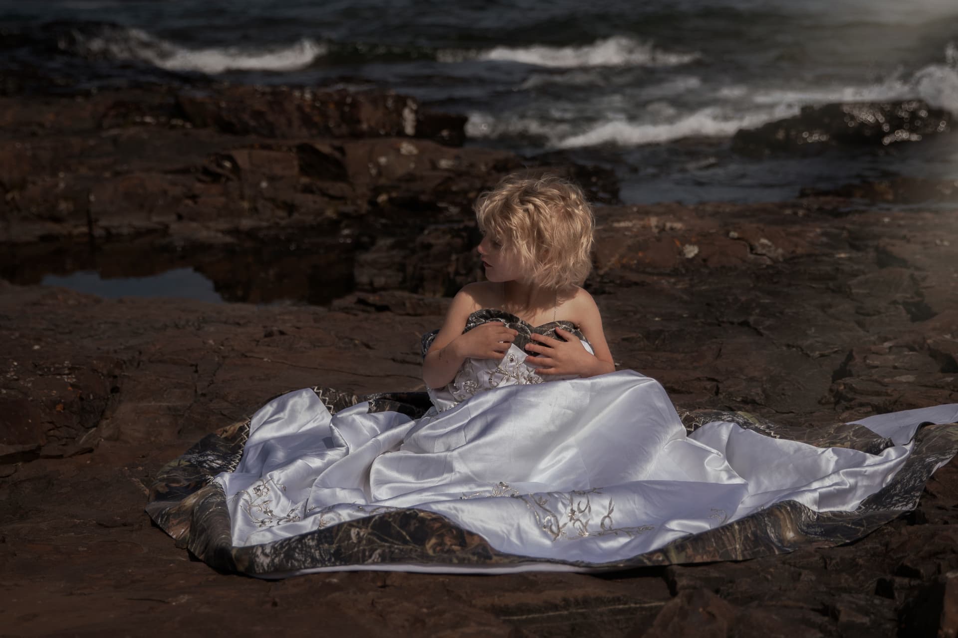 Creative portrait in a flowing dress by the sea